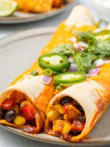 A close up image of a serving of vegetarian enchiladas on a plate.