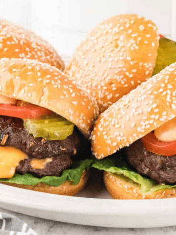 A close up picture of four Air Fryer Lucy Burgers on a plate.