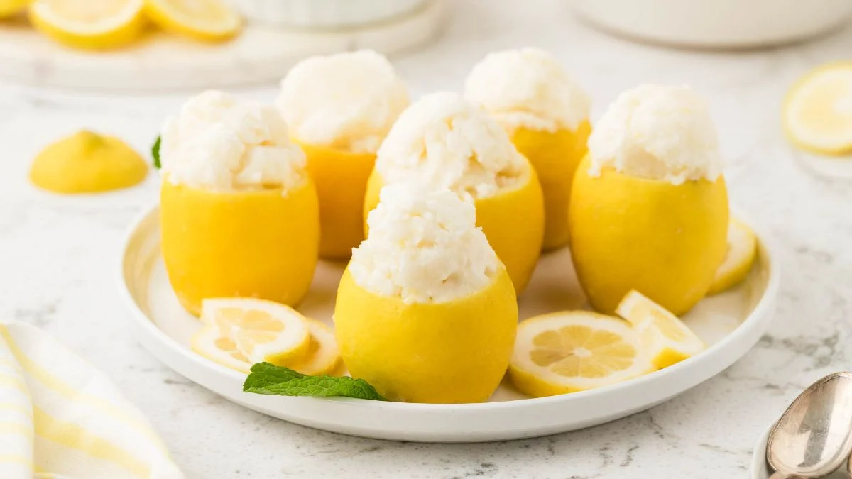 A plate with lemons full of Lemon Sorbet.