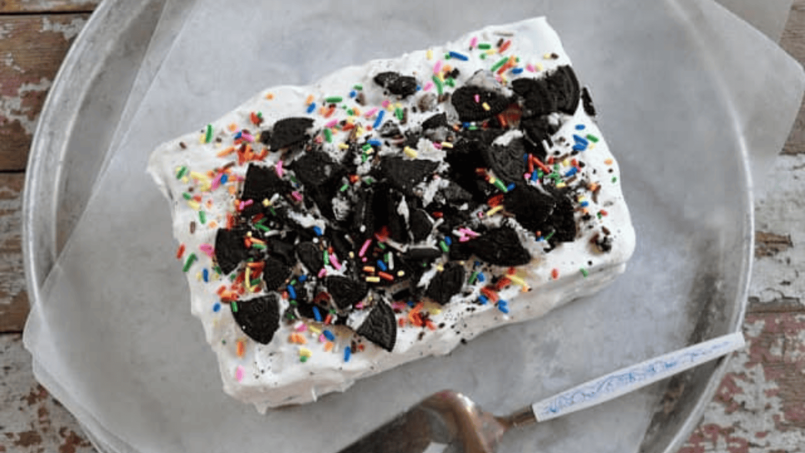 Oreo Ice Cream Cake slice on a plate.
