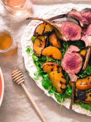 A plate full of Peach Honey Grilled Lamb Chops.