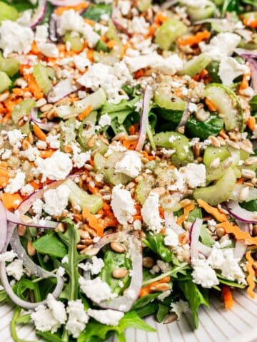 A close up of Spinach and Arugula Salad on a plate.
