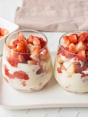 An image of two glasses filled with strawberry tiramisu.
