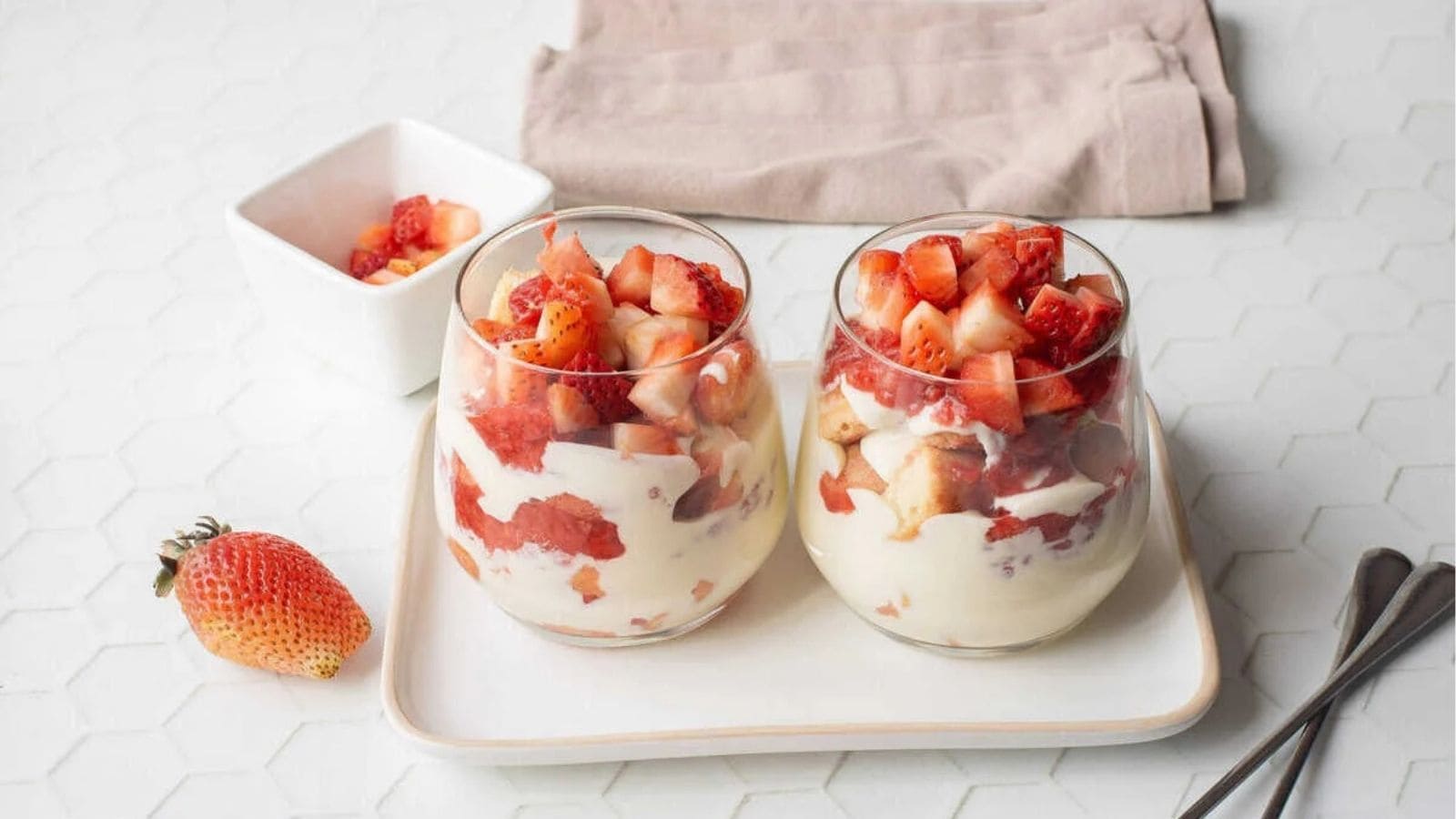 An image of two glasses filled with strawberry tiramisu.