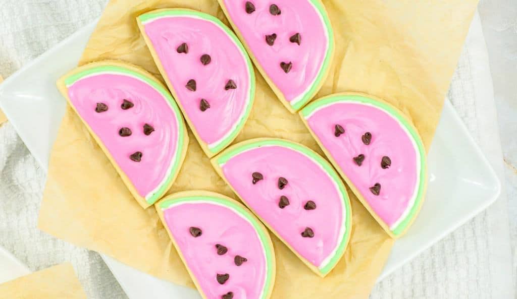 An overhead shot of watermelon sugar cookies on a plate.