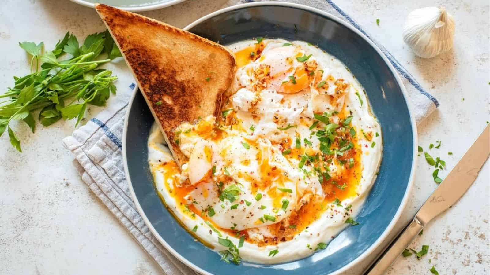 An overhead image of Cilbir, Turkish eggs, on a serving plate.