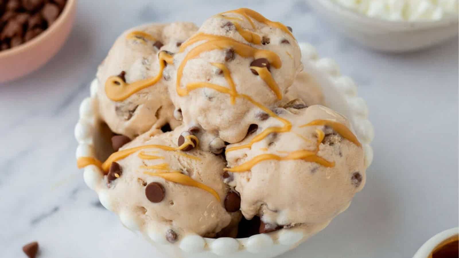 A close up image of cottage cheese ice cream drizzled with peanut butter.
