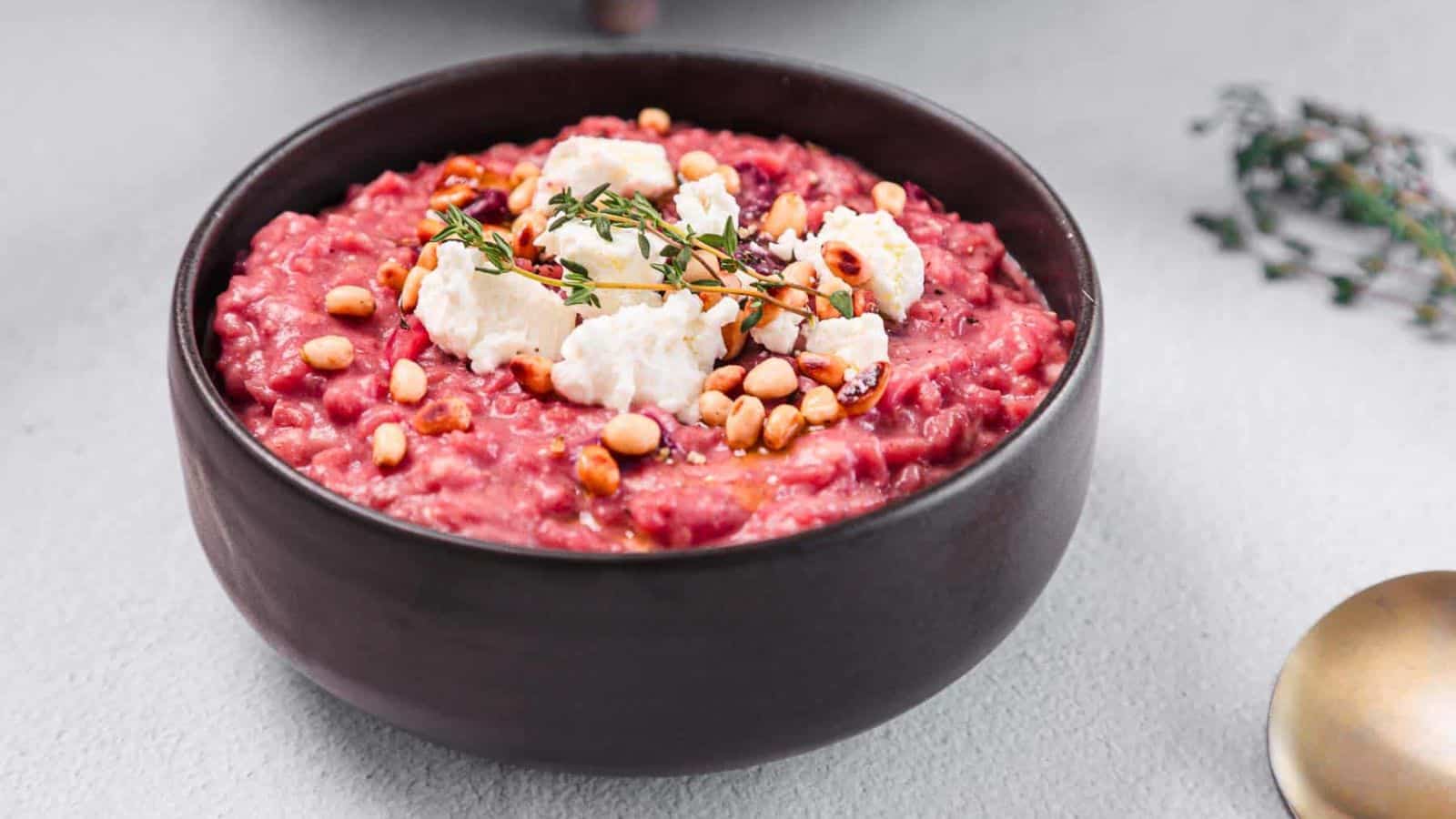 A black bowl filled with Creamy Beetroot Risotto.