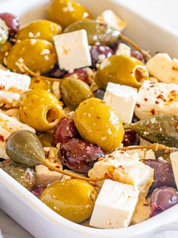 A dish filled with Marinated Olives with Feta.