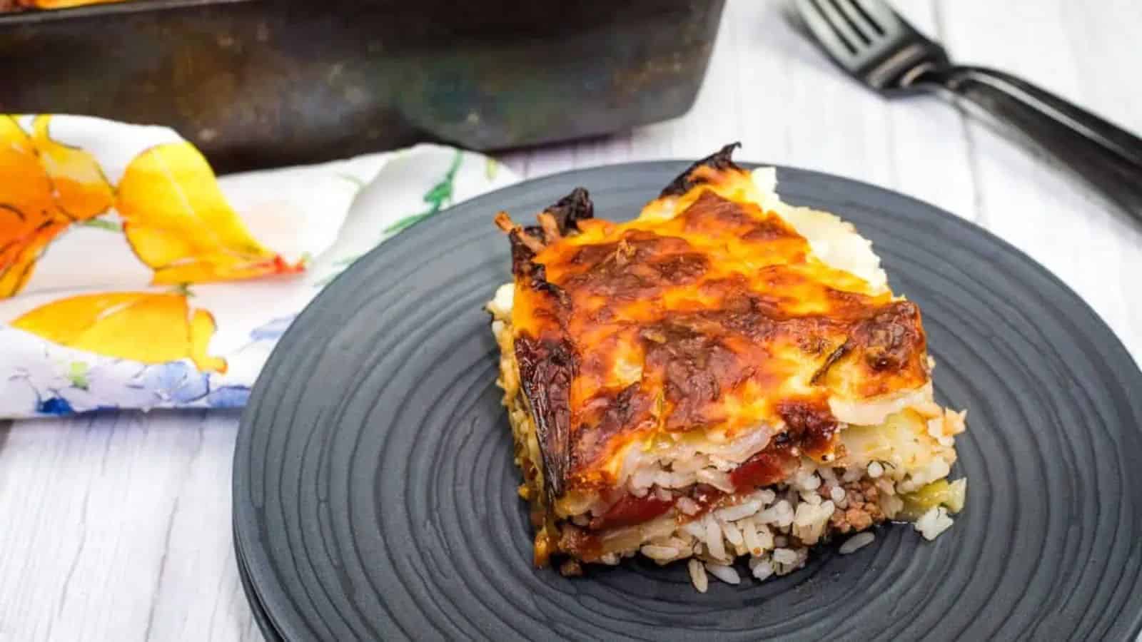 A serving of Cabbage Roll Casserole on a black plate.