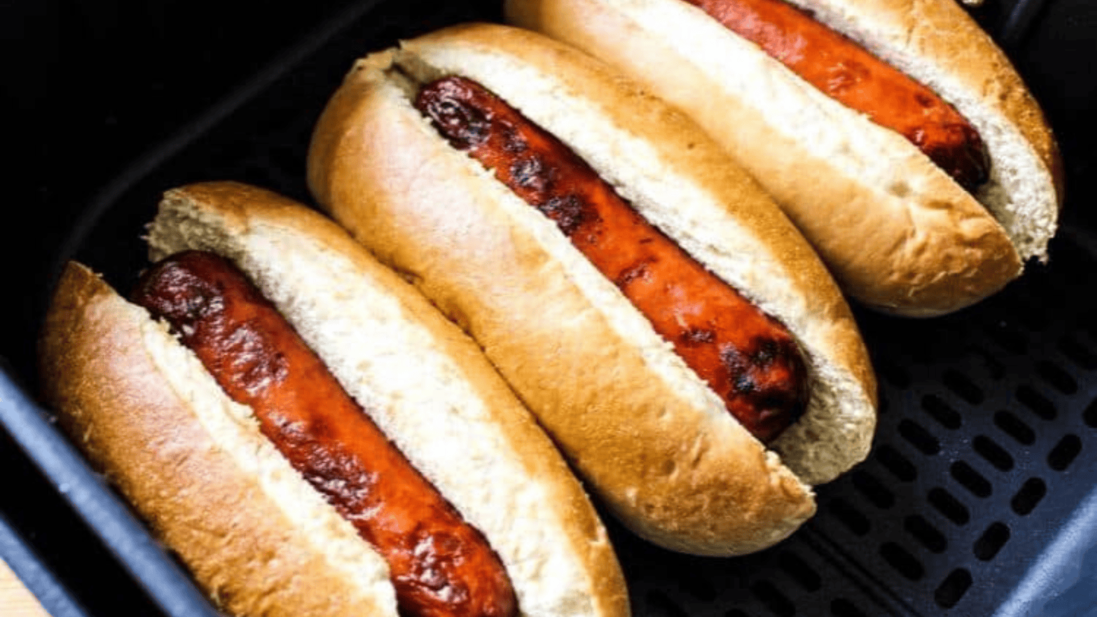 Easy Air Fryer Hot Dogs inside an air fryer.