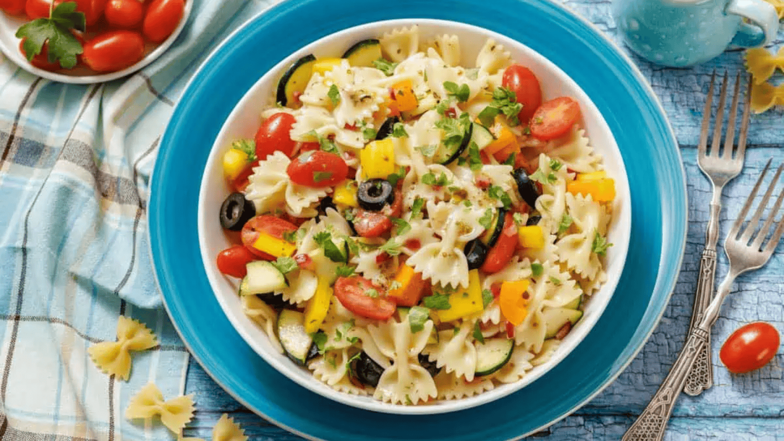 A closeup image of bow tie pasta salad in a bowl.