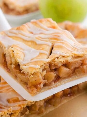 Someone holding a slice of Apple Slab Pie.