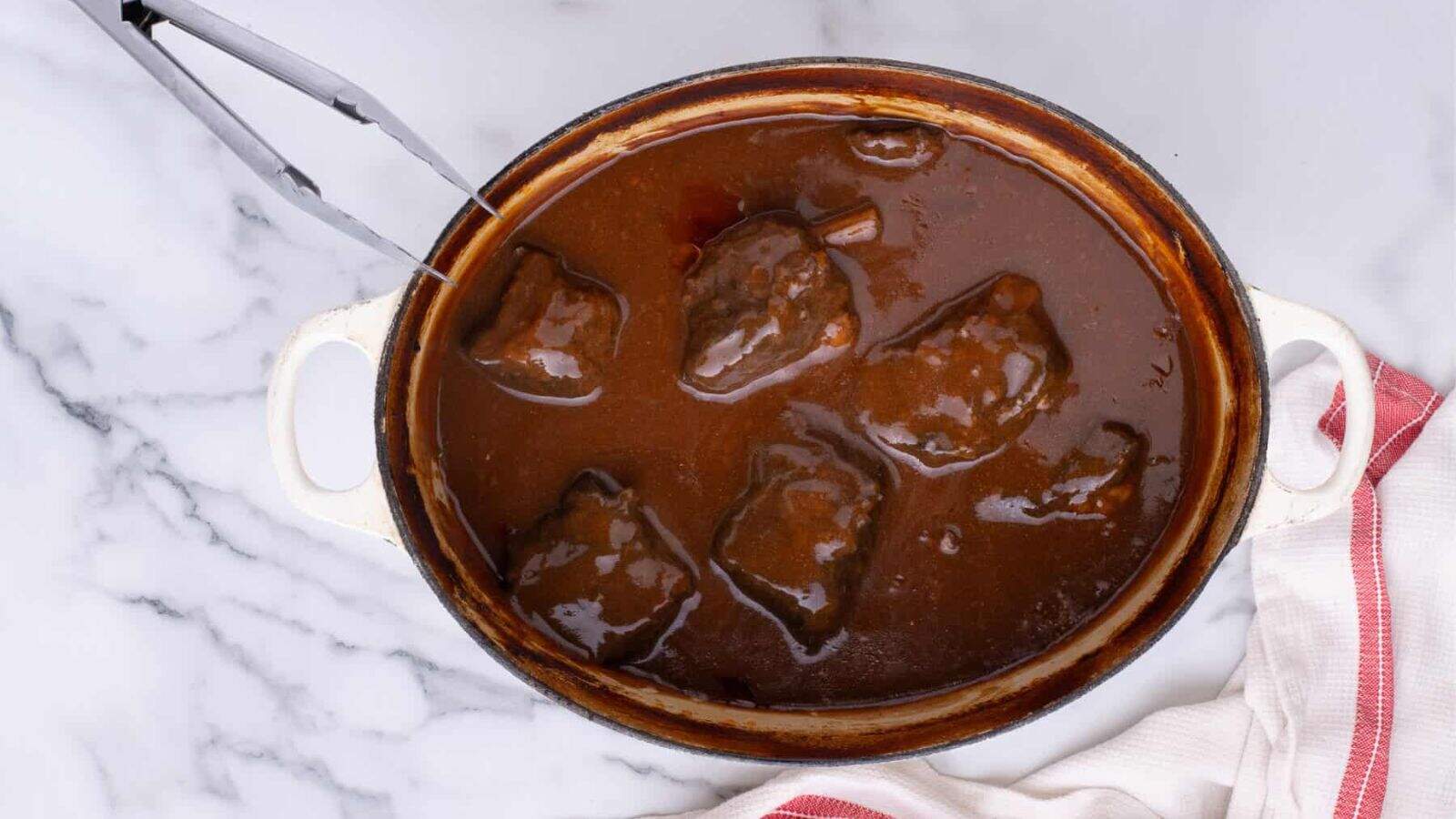 An overview of a pot of Braised Beef Short Ribs.