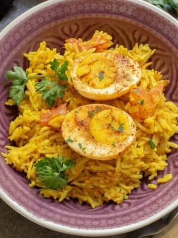 An overhead image of egg biryani in a serving bowl.