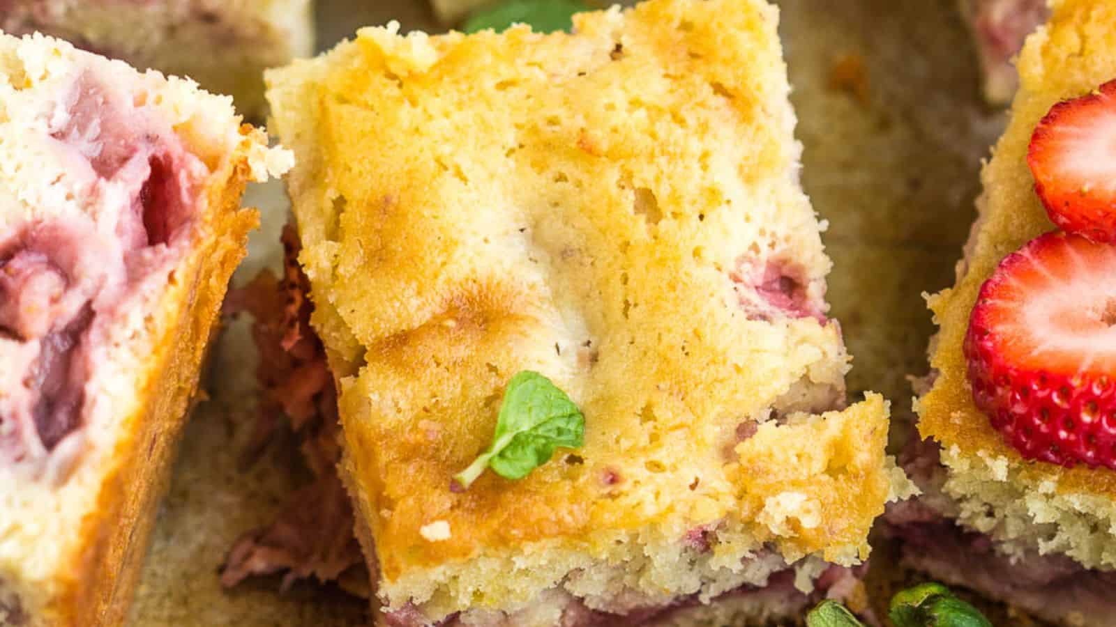 A close-up vie of Fresh Strawberry Sheet Cake slices.