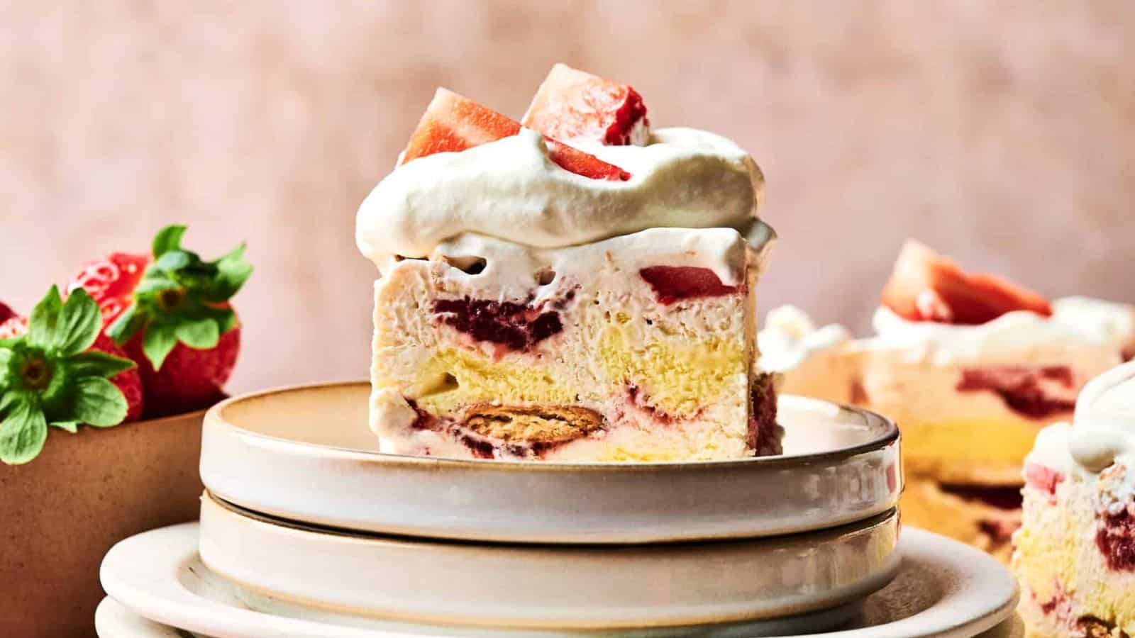 A slice of Ice Cream Cake on a stack of plates.