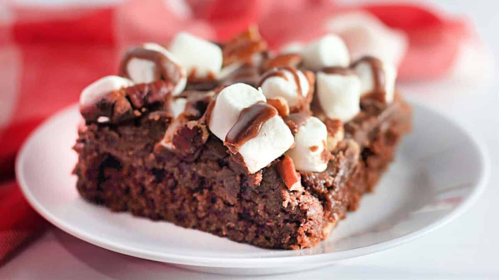 A slice of Rocky Road Texas Sheet Cake on a white plate.