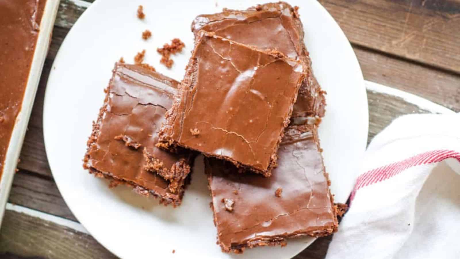 A stack of Texas Sheet Cake slices on a plate.