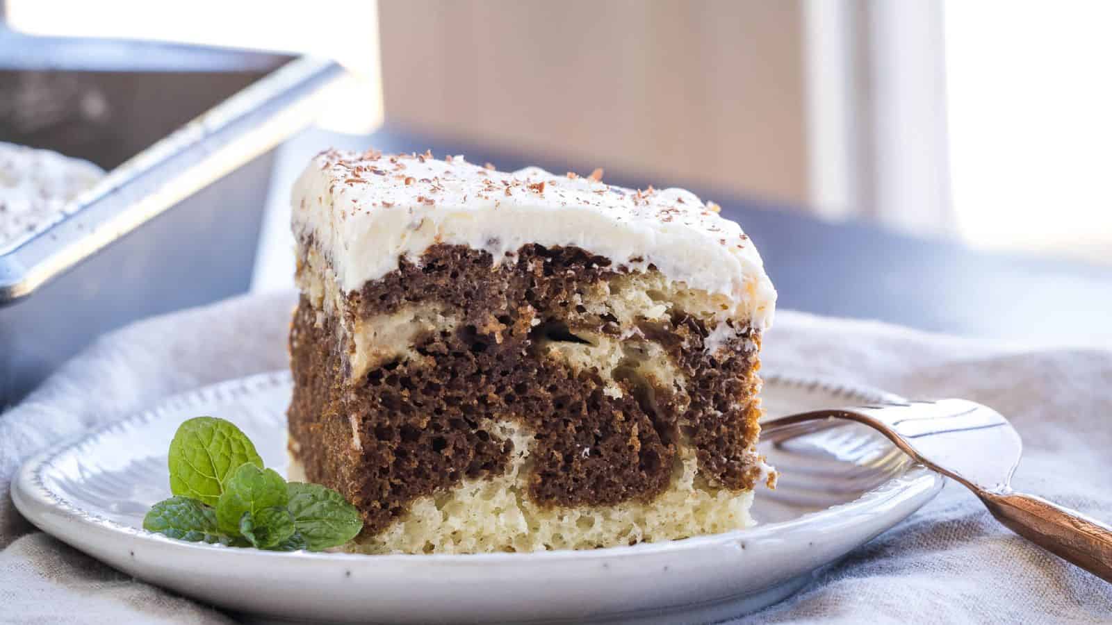 A slice of Tiramisu Sheet Cake on a white plate with a fork.