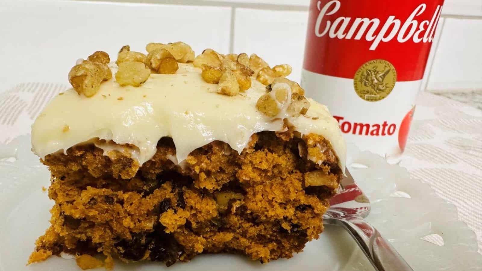 A piece of cake is sitting on a plate next to a can of soup.