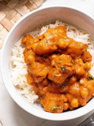 A bowl of rice topped with chickpea peanut butter curry.