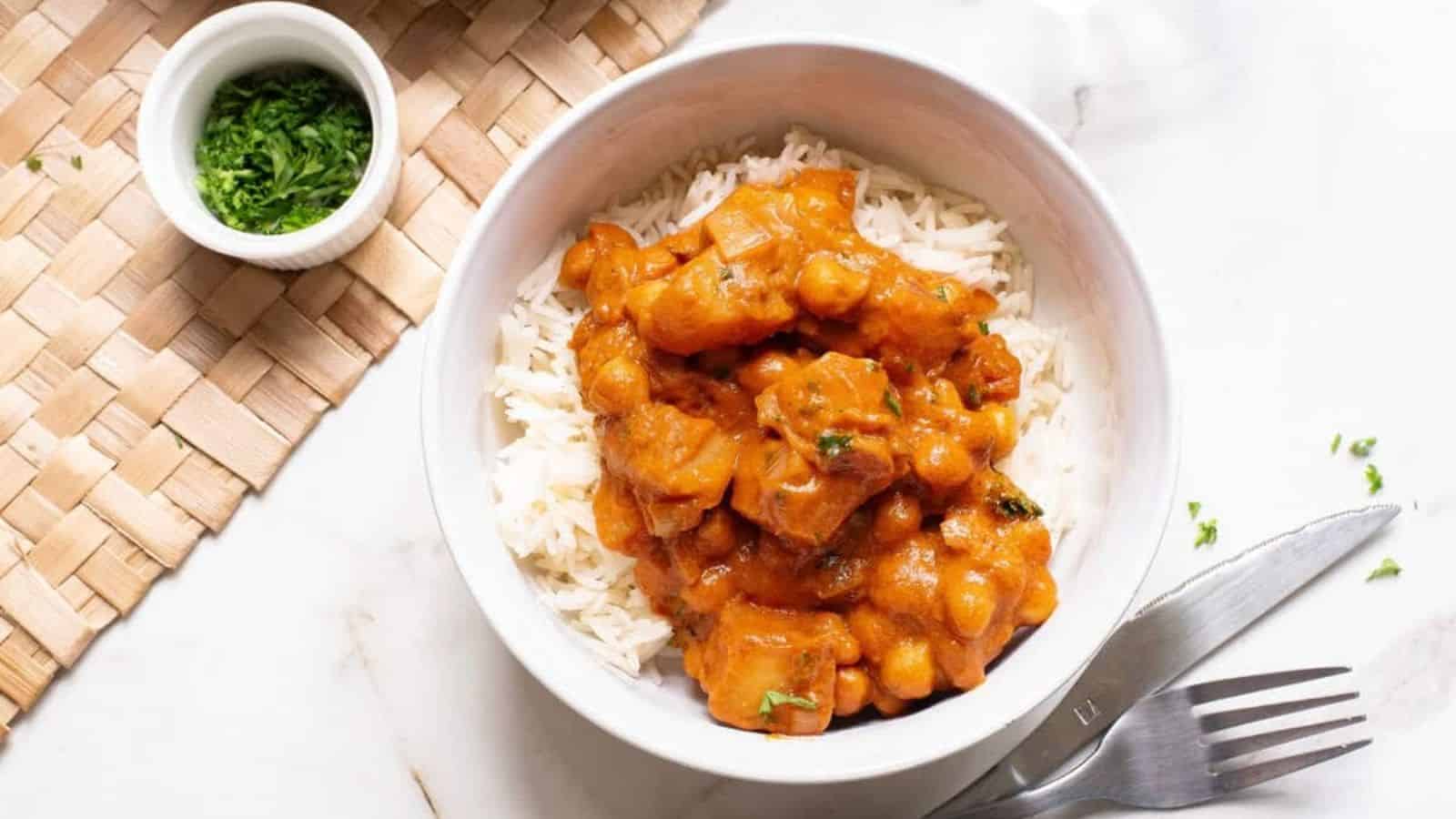A bowl of rice topped with chickpea peanut butter curry.
