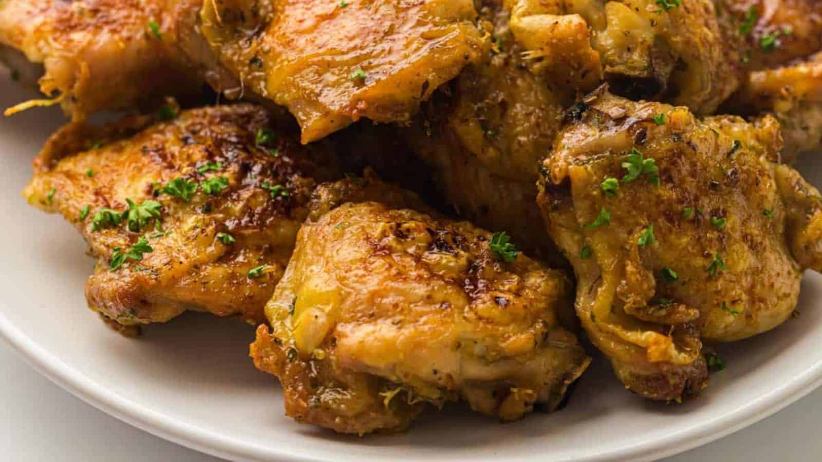 A close-up image of a plate full of Crispy Air Fryer Chicken Thighs.