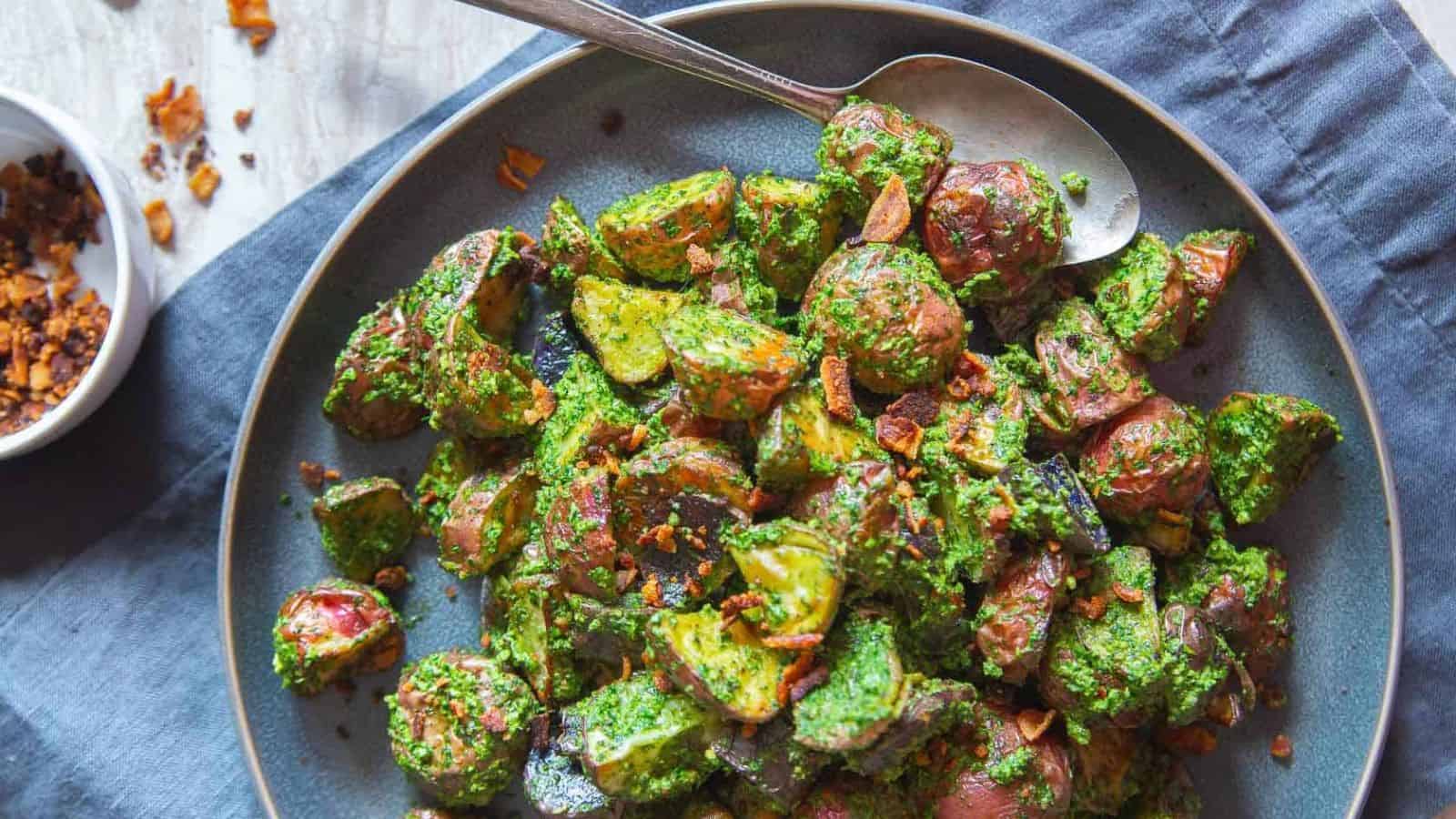 A plate of Roasted Pesto Potatoes with a spoon.