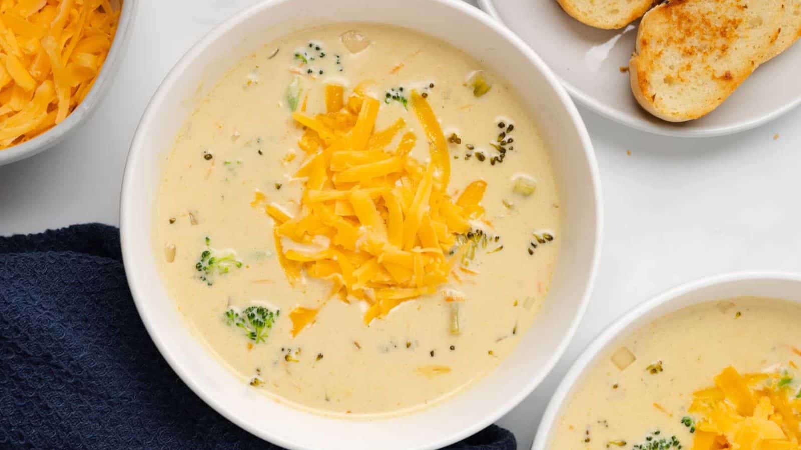 An overview of a bowl of broccoli cheese soup.