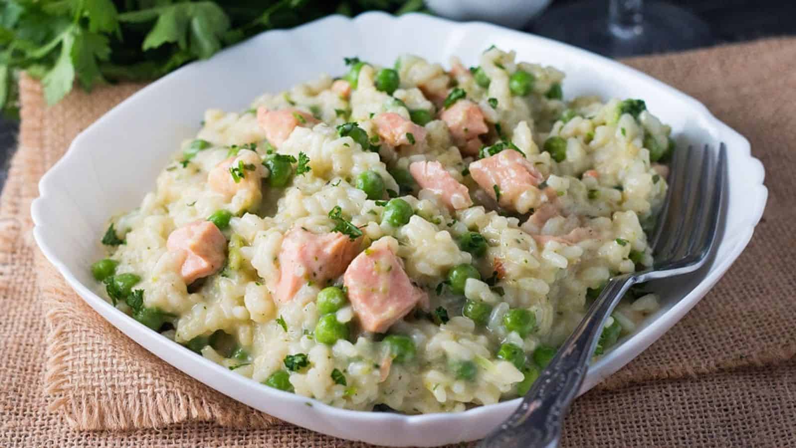 Easy Salmon and Pea Risotto on a white dish with a fork next to it.