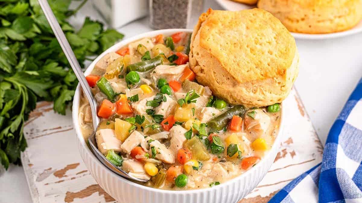 A bowl of Slow Cooker Chicken Pot Pie with a biscuit on top.