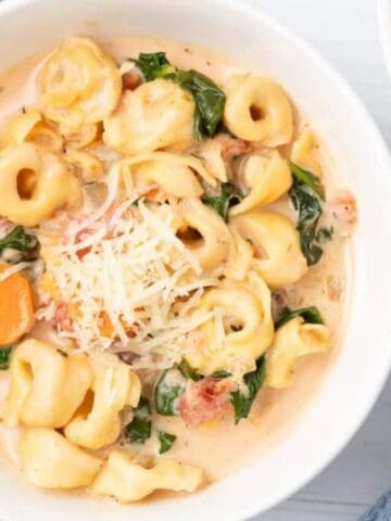 An overhead image of slow cooker tortellini soup in a bowl.