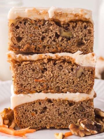 A stack of three Carrot Cake Bars on a plate.