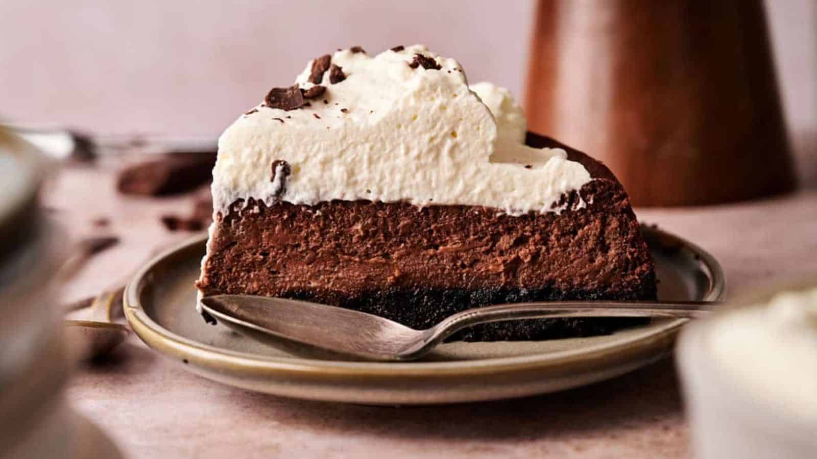 A slice of Chocolate Cheesecake on a plate with a spoon.