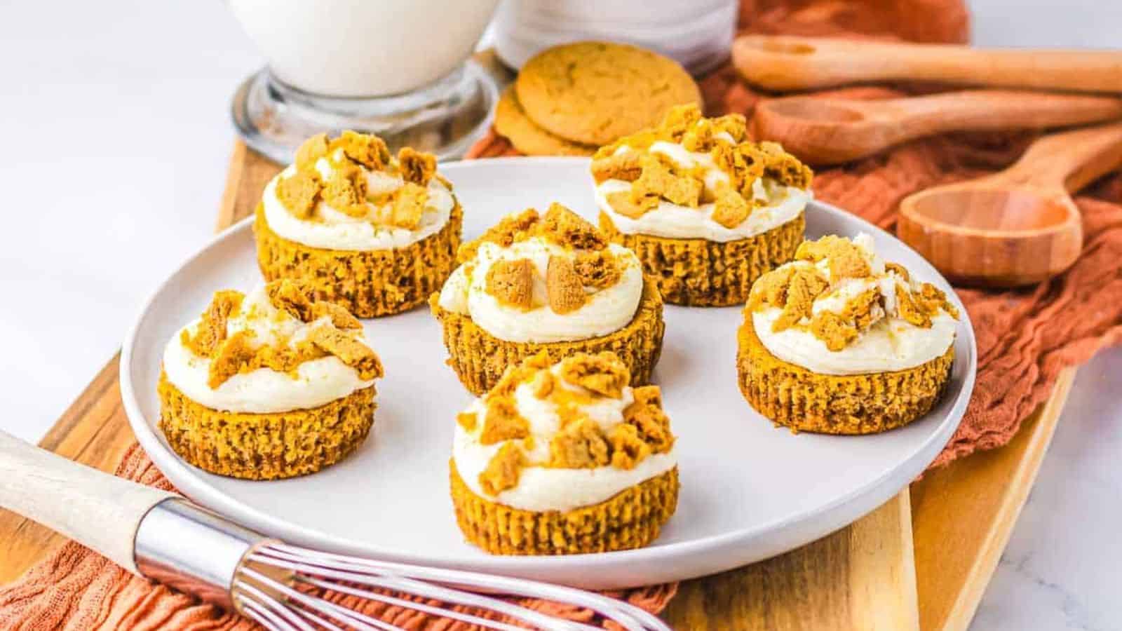A plate of Mini Gingerbread Cheesecakes on a wooden board.