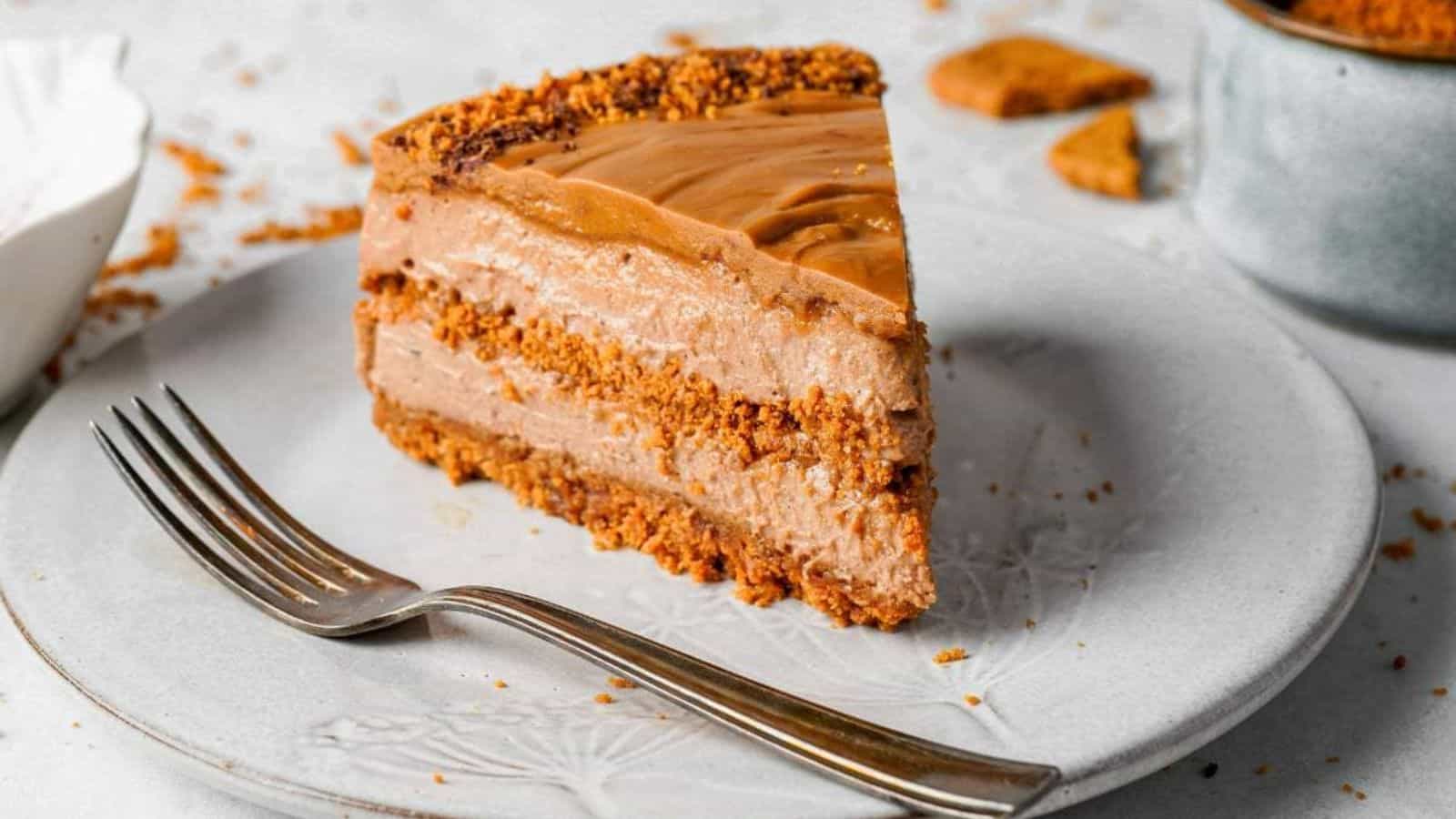 A slice of No-Bake Biscoff Cheesecake on a plate with a fork.