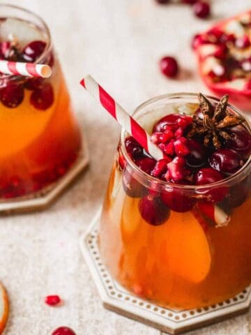 An image of two glasses of Non-Alcoholic Sparkling Apple Cider Mocktails.