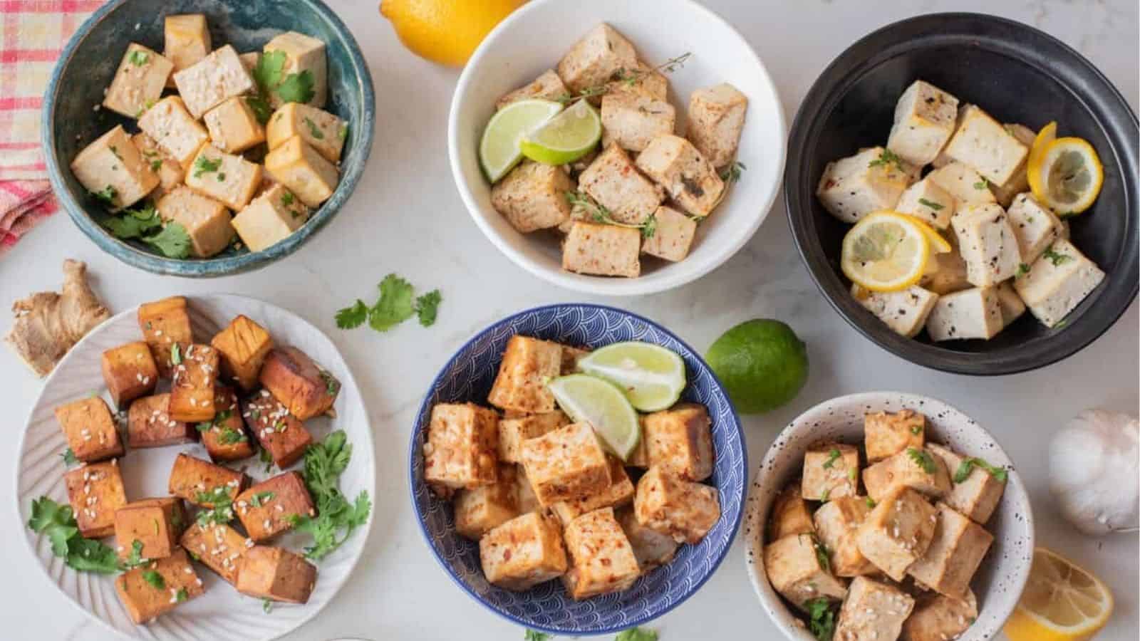 An overhead image of six tofu dishes served in different bowls.