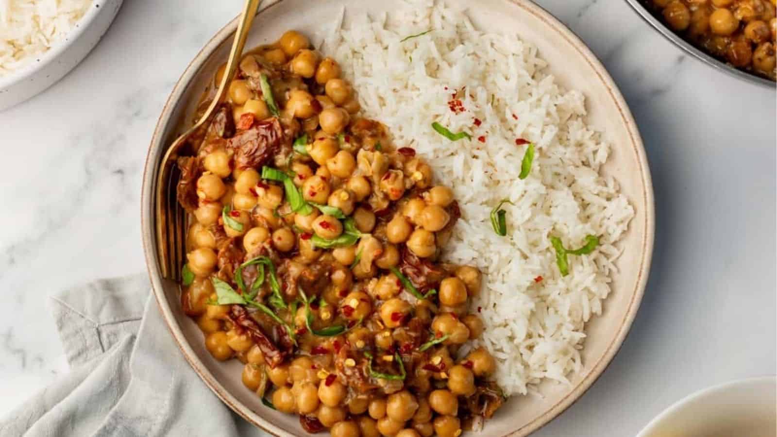 An overhead image of marry me chickpeas served on a plate with rice.