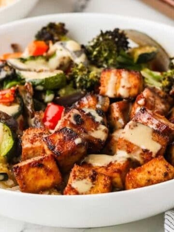 A close up image of sheet pan tofu and veggies served in a bowl.