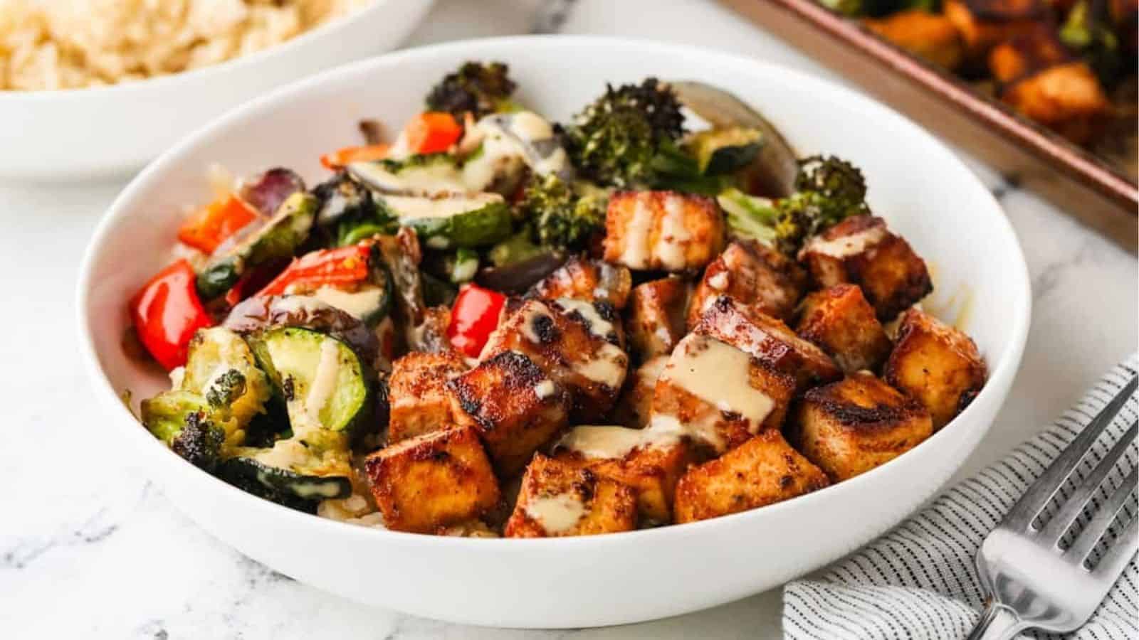 A close up image of sheet pan tofu and veggies served in a bowl.