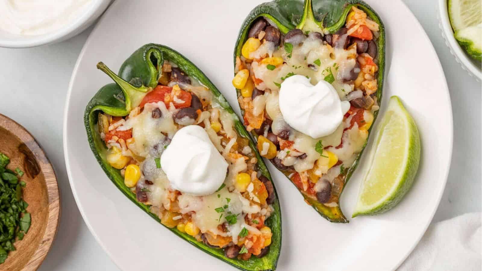 An overhead image of two pieces of stuffed poblano peppers served on a plate.