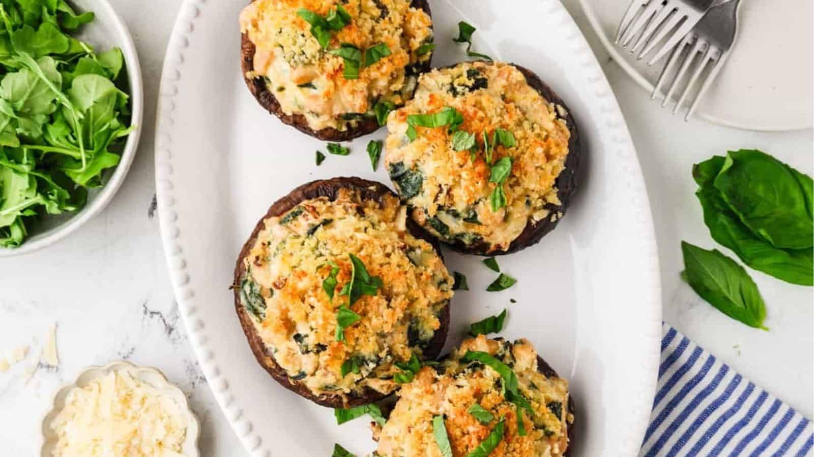 An overhead image of vegetarian stuffed portobello mushrooms on a plate.